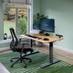 Electric Standing Desk with ComfortEdge in 48x30 Butcher Block in lowered position at home